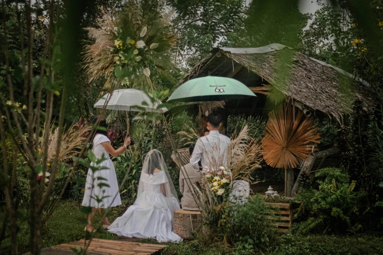 a newly married couple on a patio under an umbrella