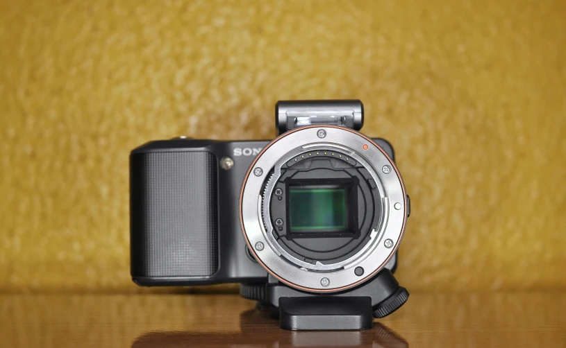 an electronic camera sits on a table