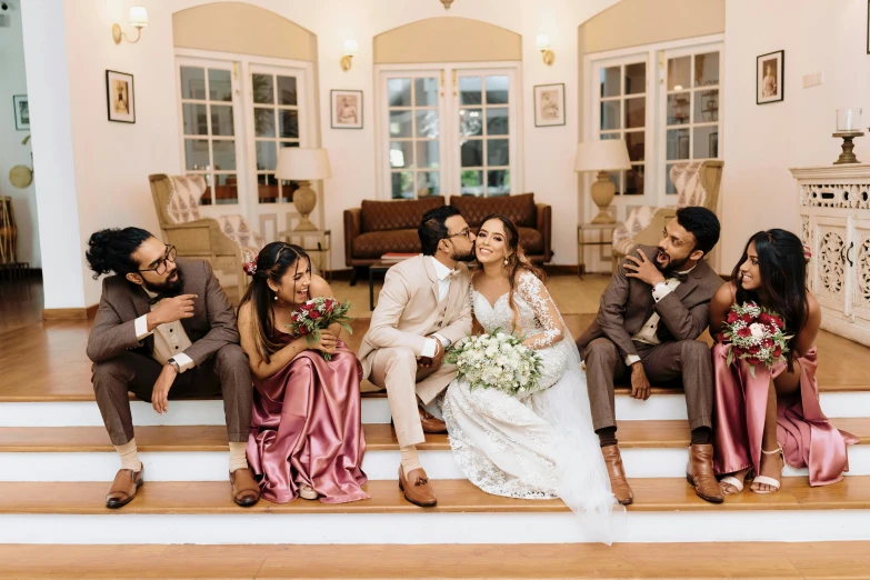 the newly married couple pose on the stairs