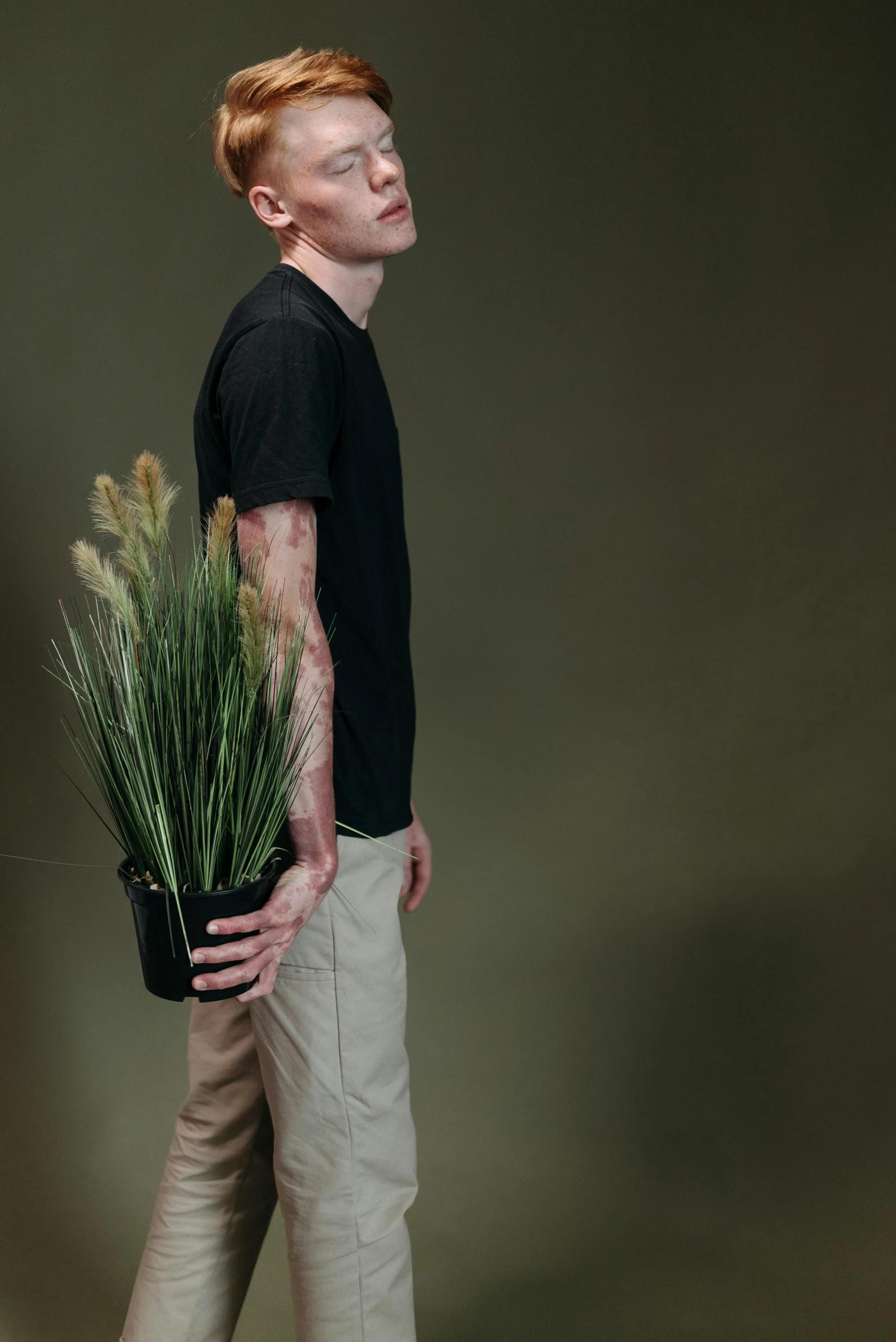 a man is carrying plants in his hands