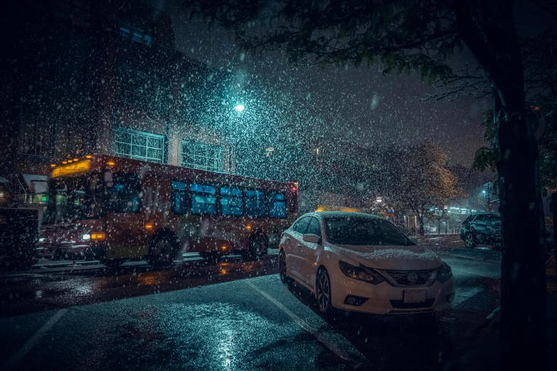 the city bus is driving through the rain