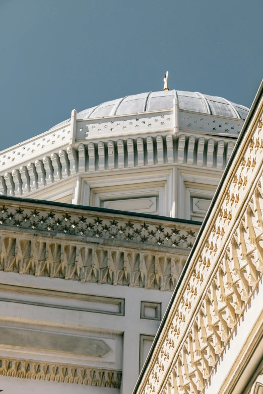 a close up of the top of a building with a statue