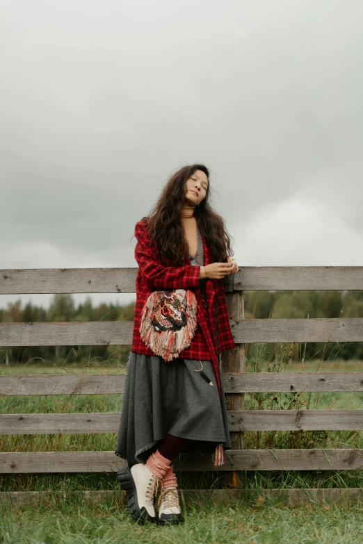 a woman wearing boots is posing for the camera