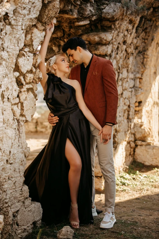 a man and woman in black dress emcing