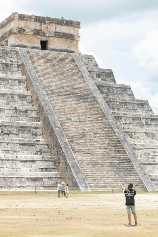 several men standing in front of an ancient building