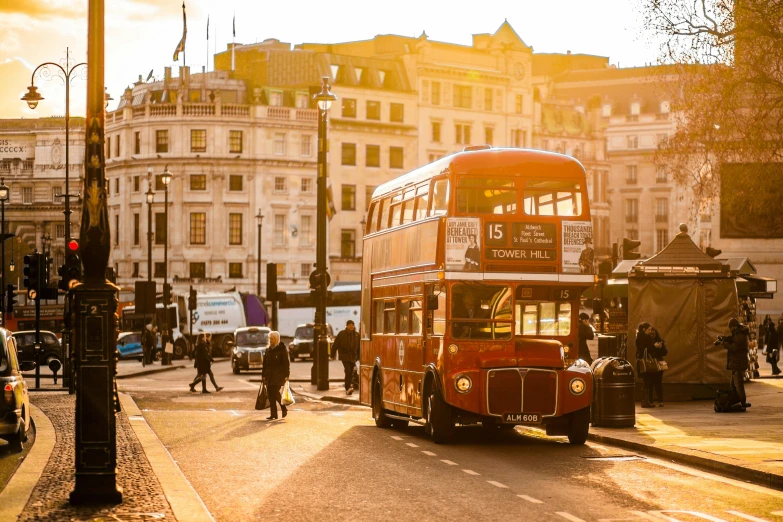 a red double decker bus on city street