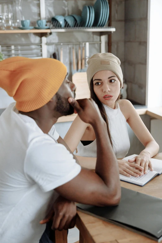 a man and woman sitting at the counter talking