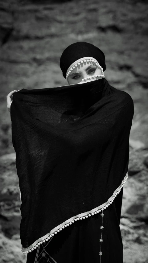 black and white pograph of a woman covering her head