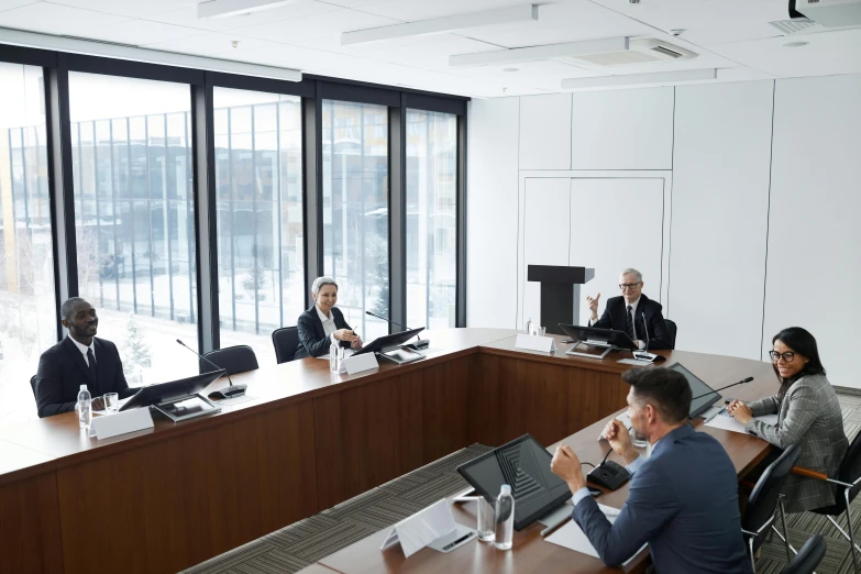 a group of people that are sitting around a conference room table