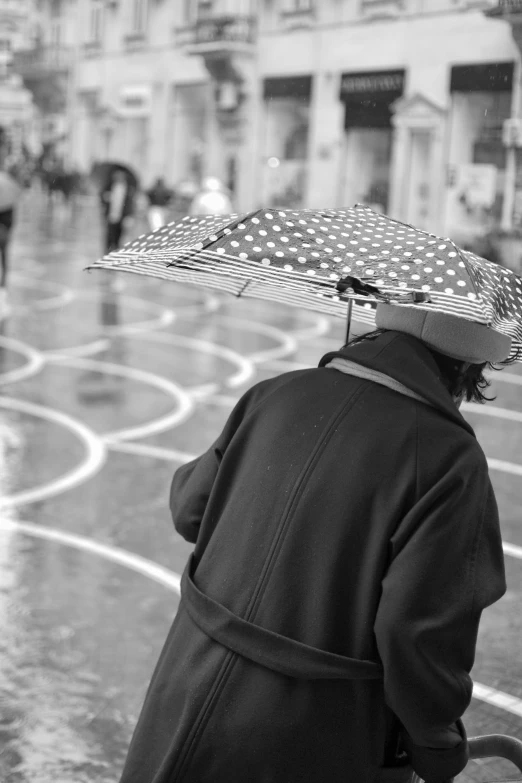 a person standing in the rain with an umbrella