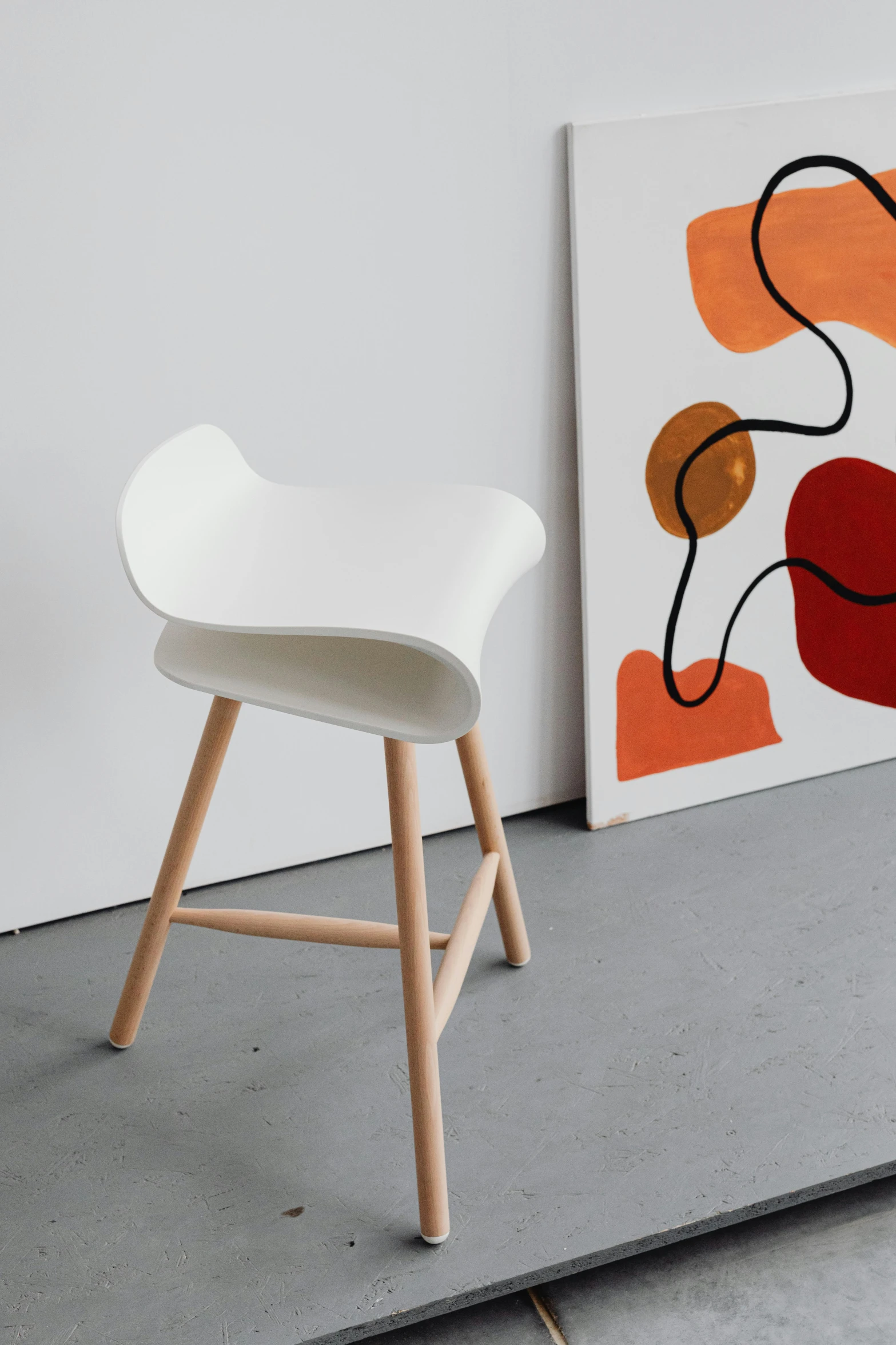 this is a chair and a painting sitting on the ground