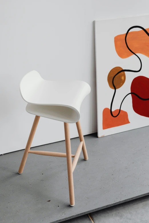 this is a chair and a painting sitting on the ground