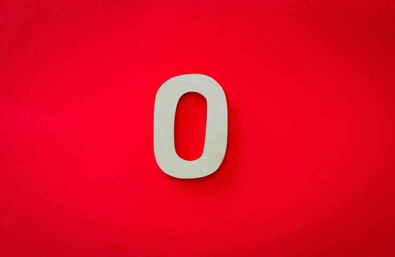 a red wall with an o for the letter o
