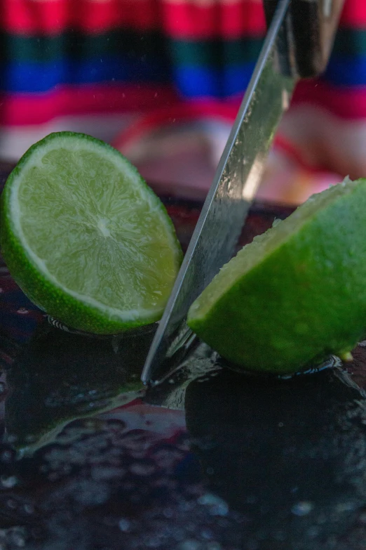 a lime and knife with a red background