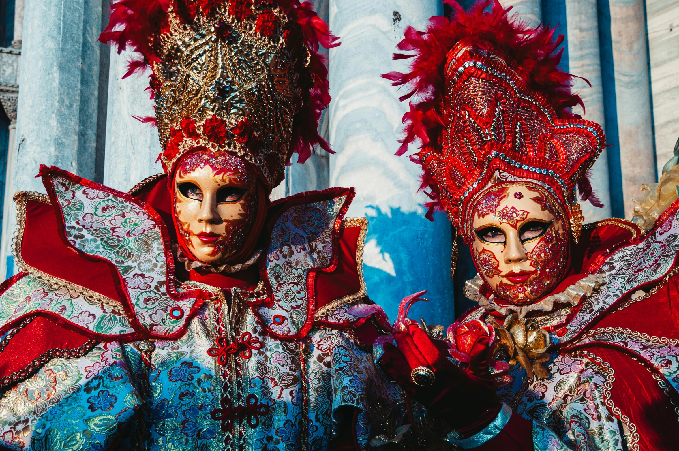 two young men in carnival costumes pose for a picture