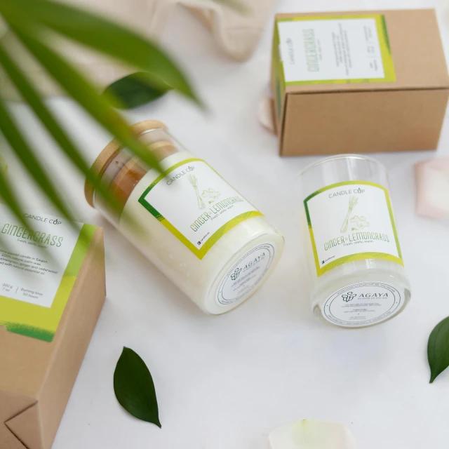 three bottles of body care sitting on top of a counter