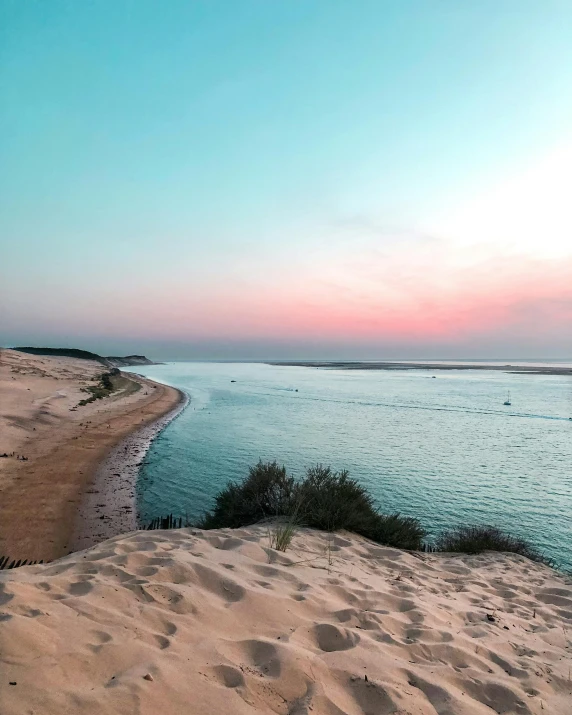 a scenic view of the beach at sunset