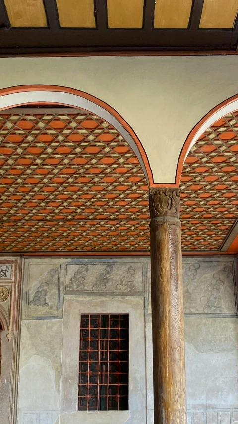 the ceiling in the building is painted orange and beige