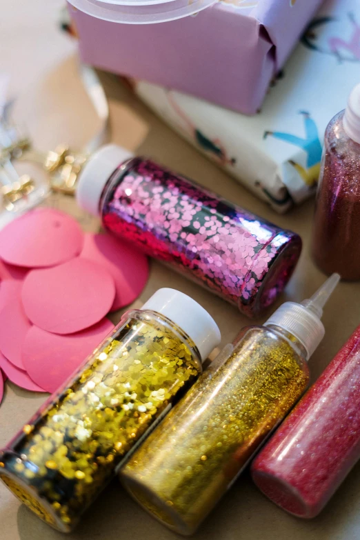 there are several bottles with glitter inside of them