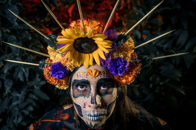 a woman with makeup and flowers on her head