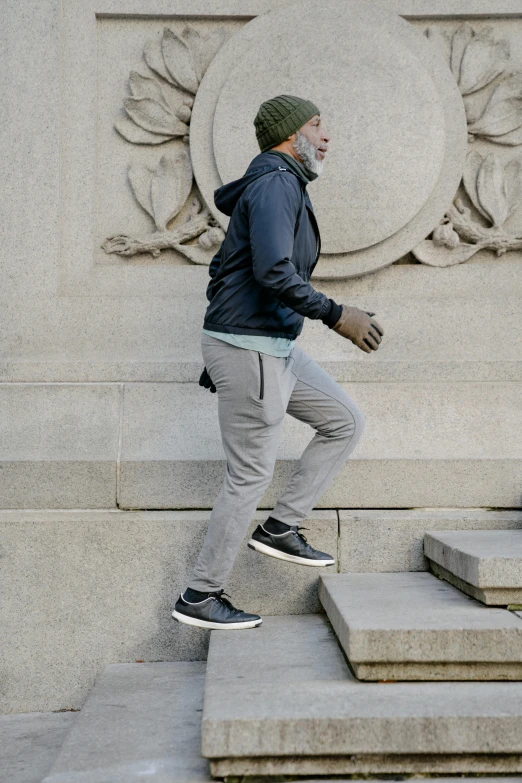 man on skate board doing tricks in front of large wall