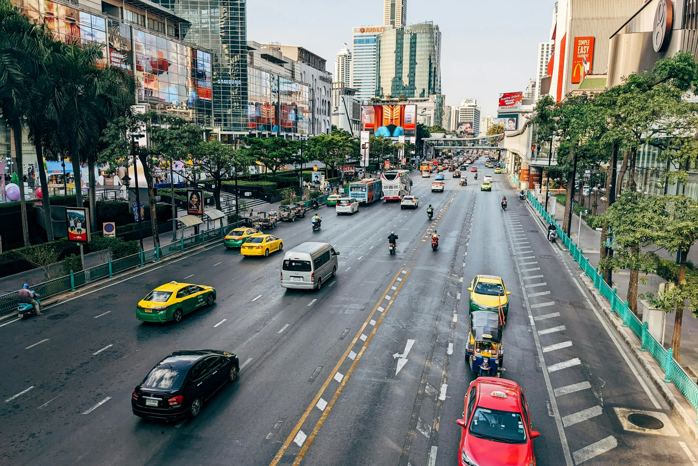 the cars are traveling on the street in the city