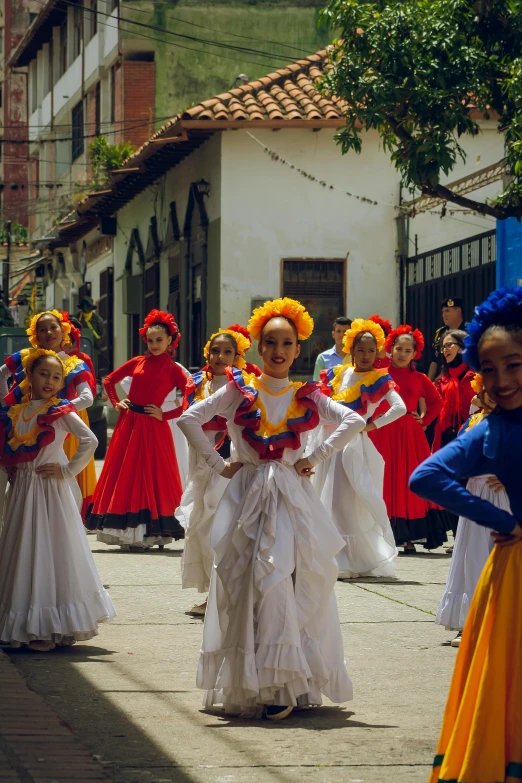 a woman is walking with several other people in mexican outfits