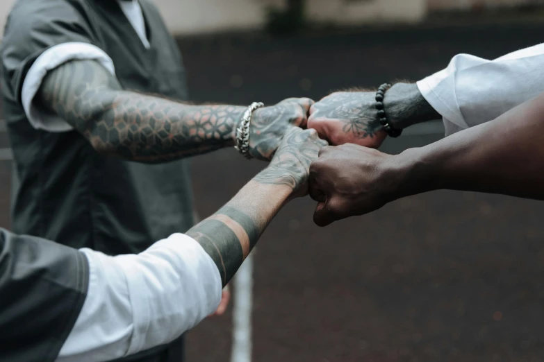 two hands holding each other as they are standing in a circle