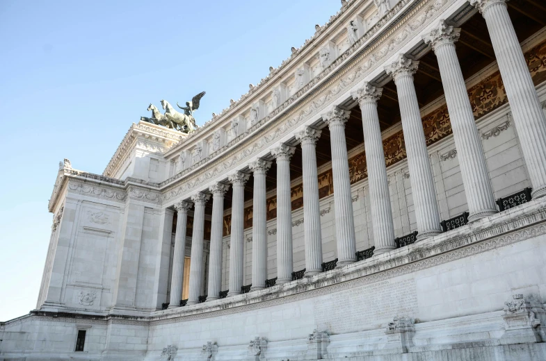 an ancient greek temple sits in the middle of a desert