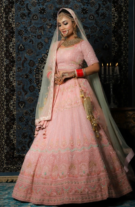 a woman in a pink wedding outfit is posing