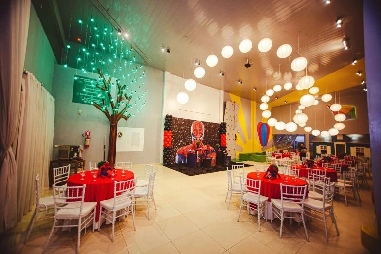 a restaurant with a red table and white chairs