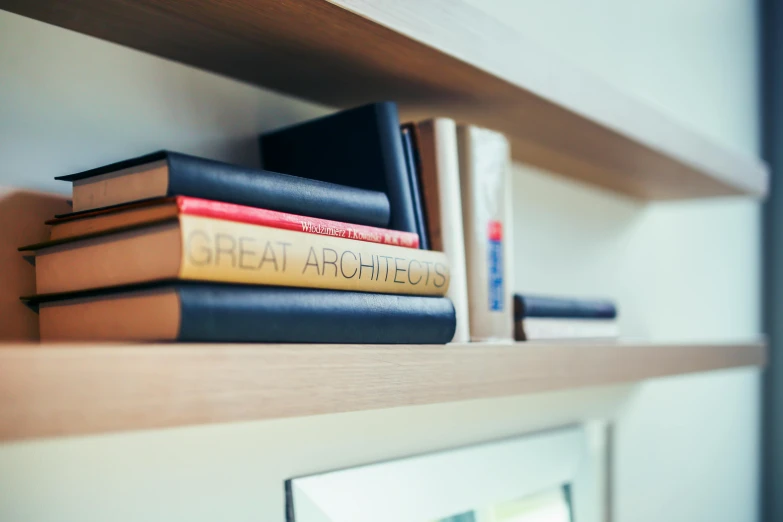 a group of books are placed on a shelf