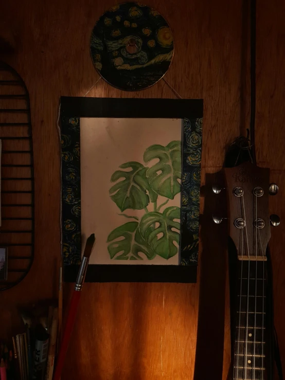 a close up of a guitar head on a wooden wall