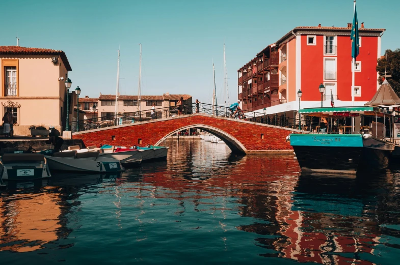 the boats are in the water on the side of the street