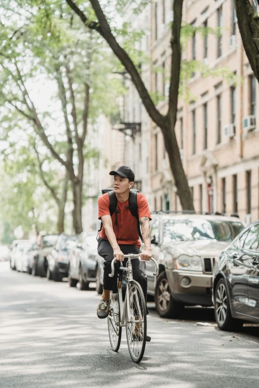 a man rides his bicycle down a city street