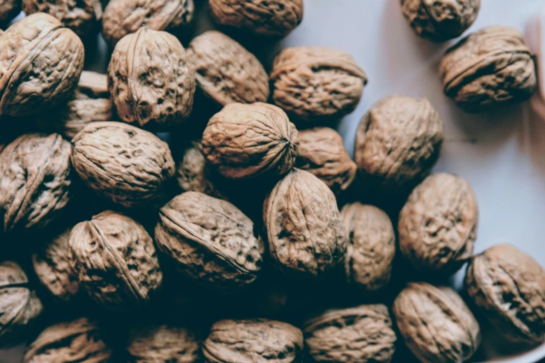 a bowl full of some very pretty walnuts