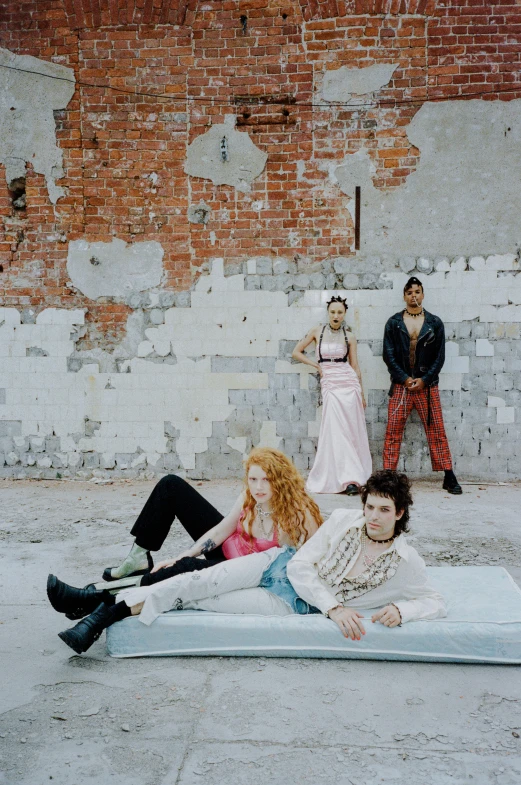 the four people are laying on the ground, one with a woman