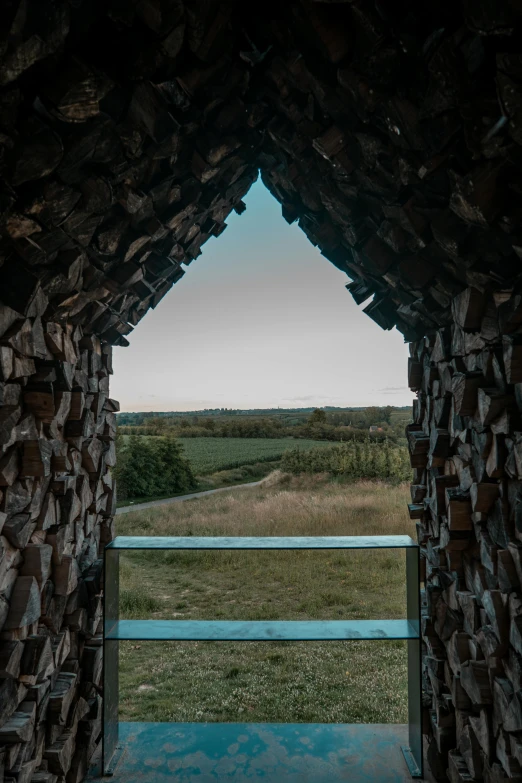 a very pretty wooden structure in the middle of a field