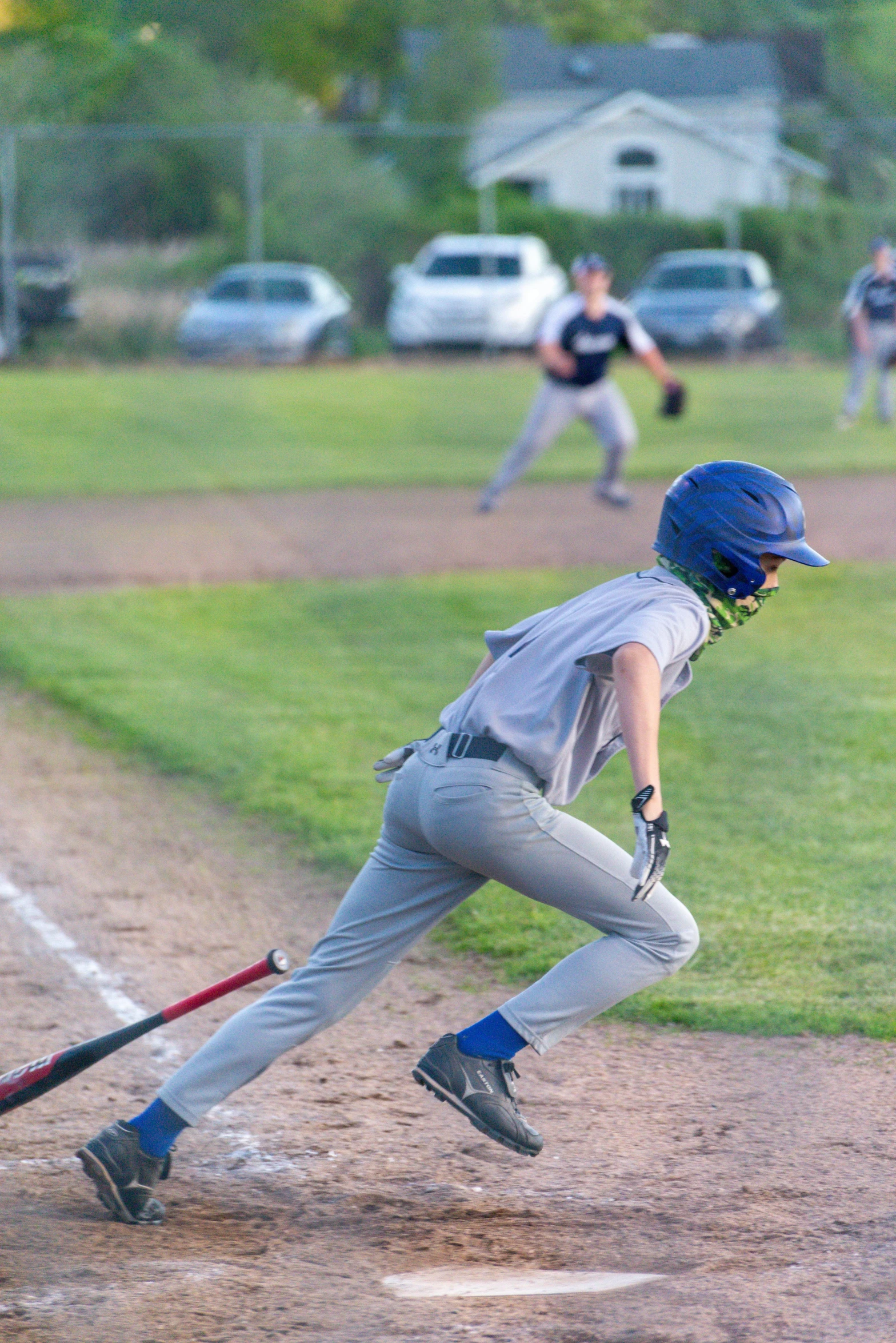 a boy swinging a baseball bat on a field