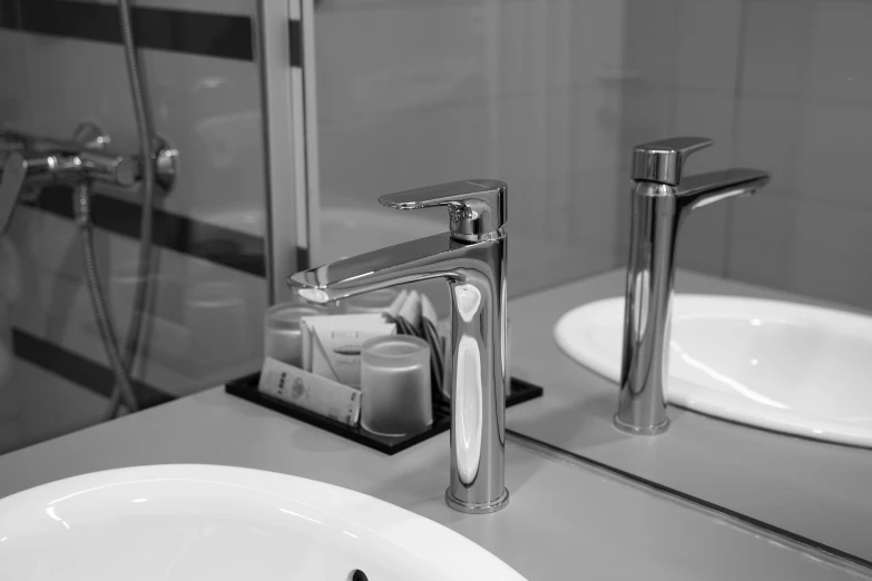 a bathroom sink with a faucet and soap dispenser