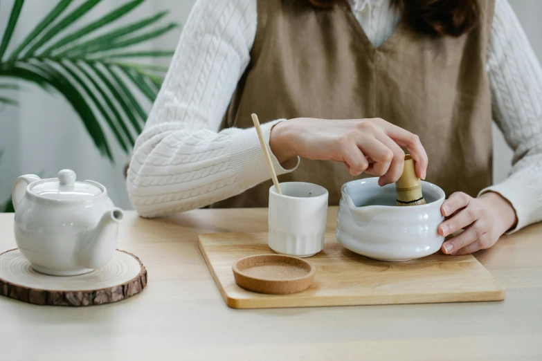 a woman who is putting a cup into her coffee