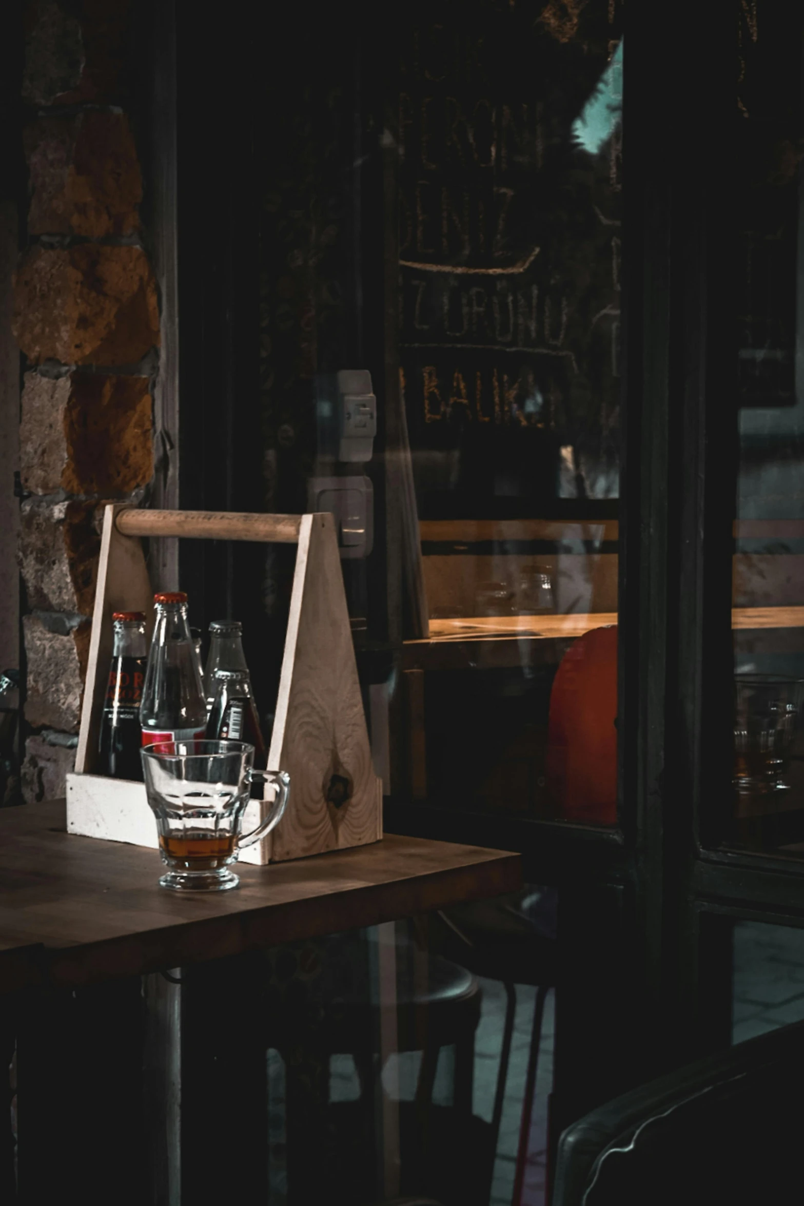 a wine bottle in a glass case sitting on a table