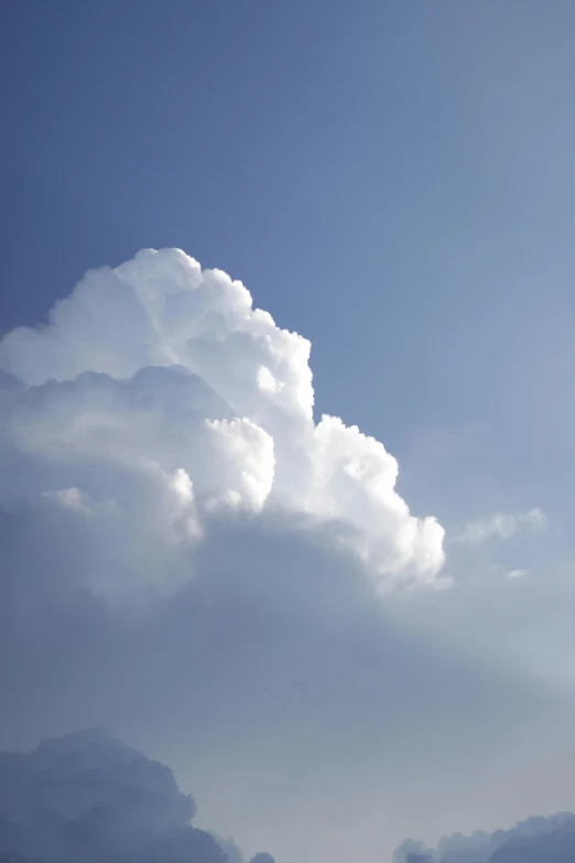 the plane is in the air on a cloudy day