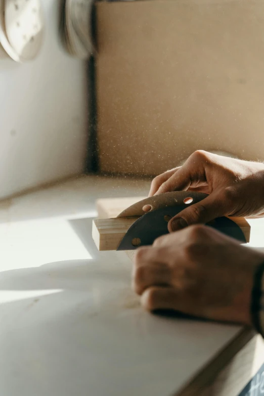 someone working on their woodwork using a planer