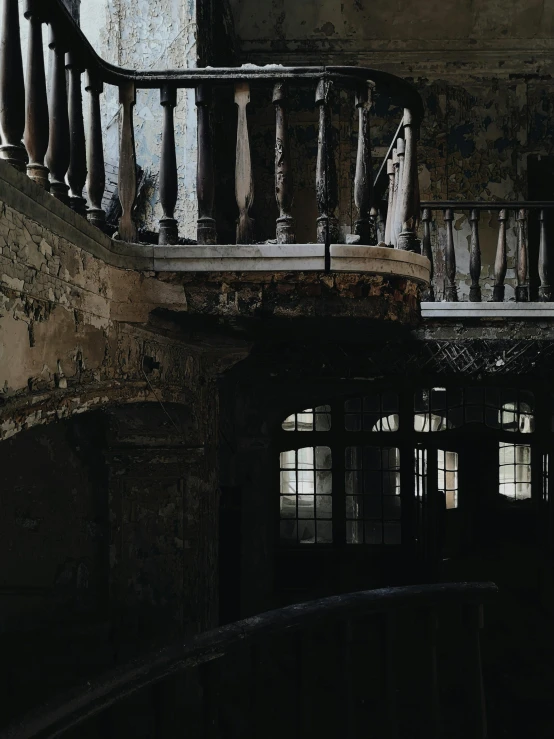 an old house with a rundown stairway and windows