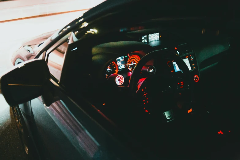 a car dashboard with red lights, and a speed gauge