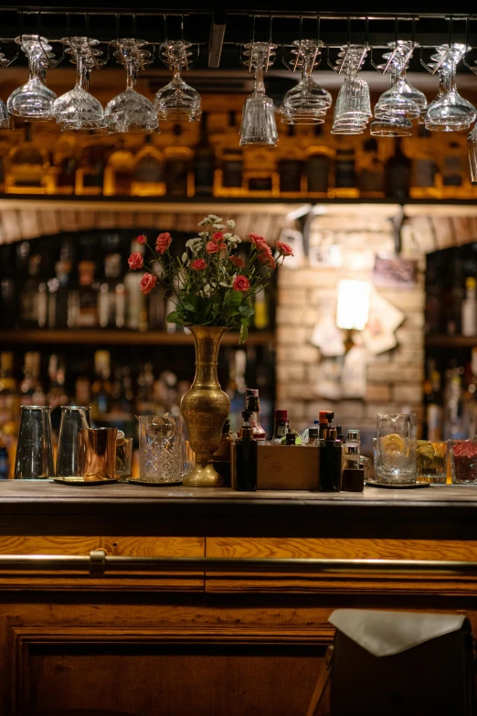 the bar has many glasses on the bar counter