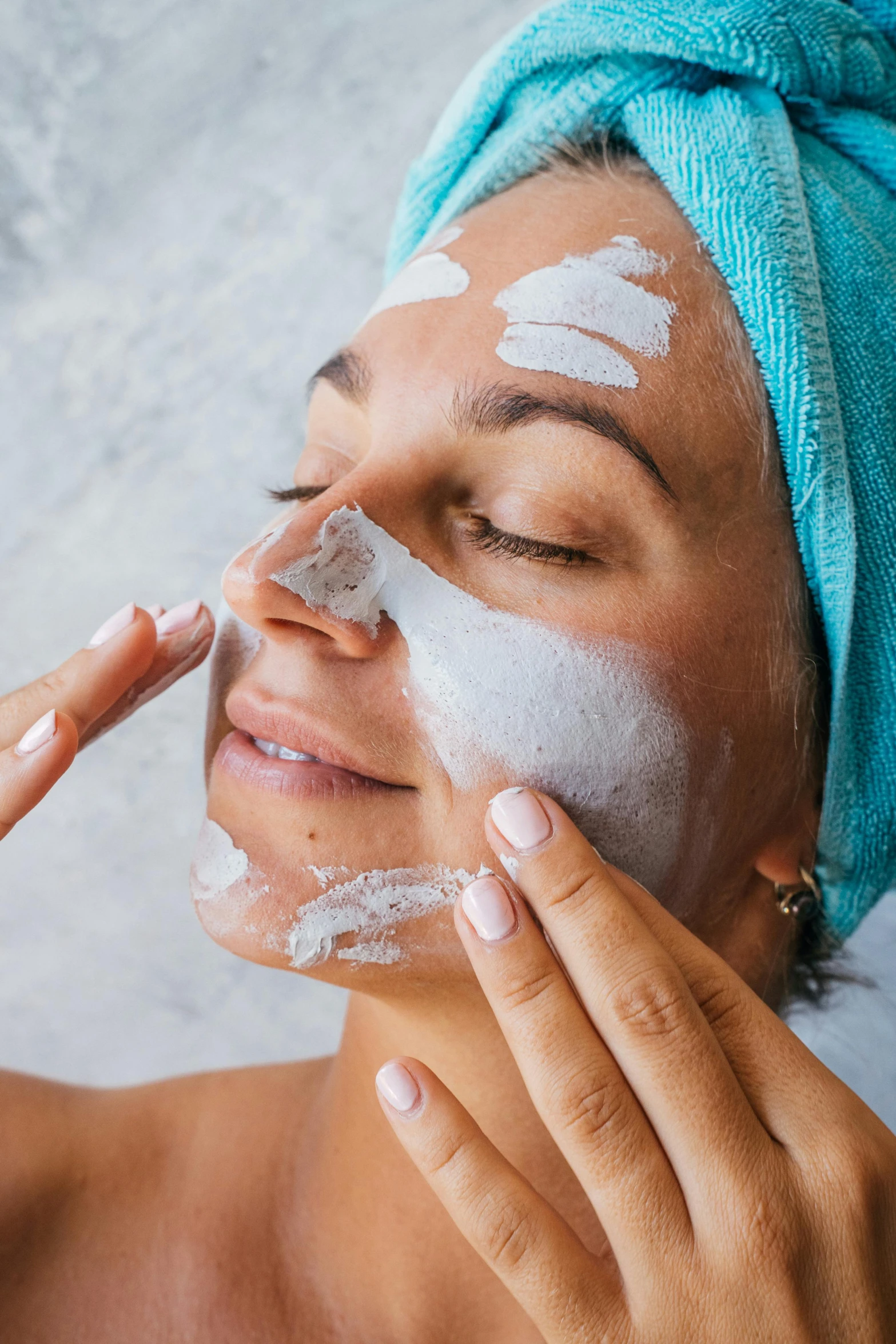 a woman has her face covered in soap and scrubbing