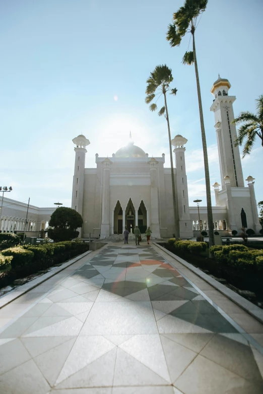 a white building surrounded by palm trees on top of it