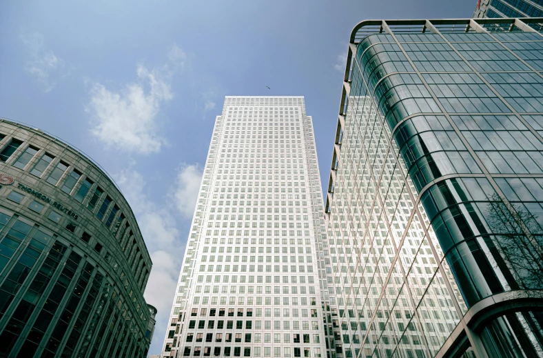 a group of skyscrs under a cloudy blue sky